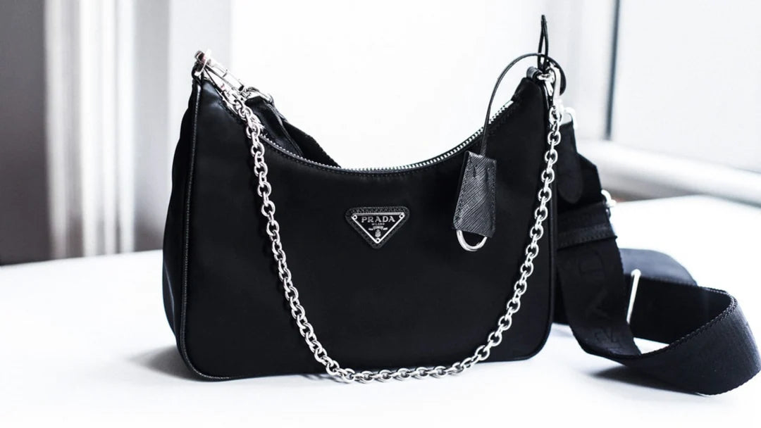 Black Prada Re-Edition nylon shoulder bag with silver chain strap and triangular logo plaque