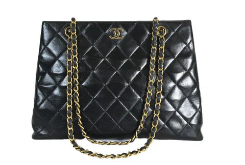 Black quilted leather Chanel tote bag with gold chain straps and CC logo hardware
