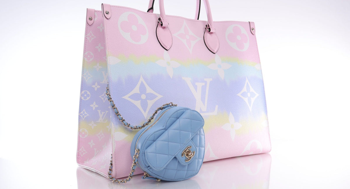 Louis Vuitton pastel tote bag with large monogram print and small blue quilted Chanel heart bag