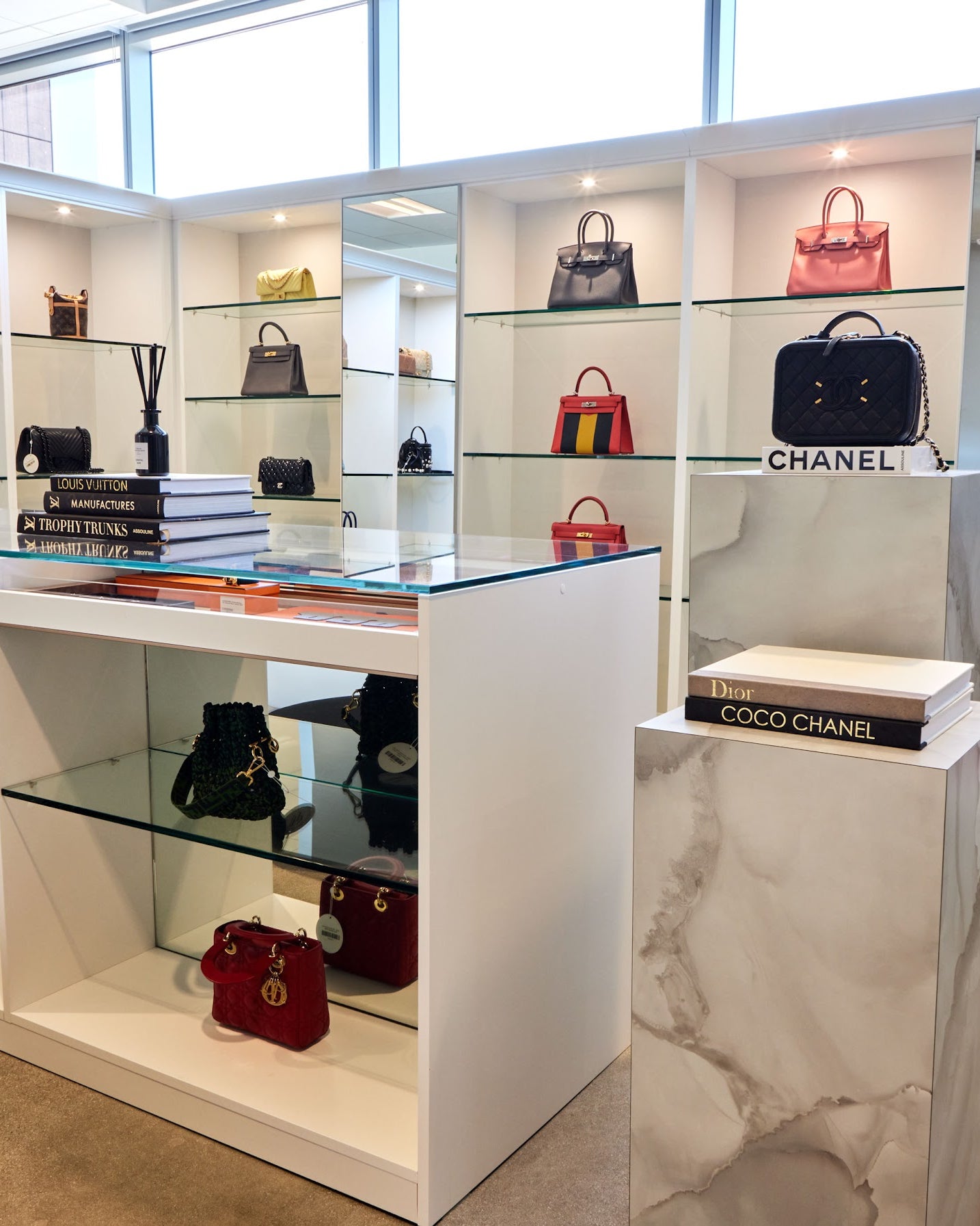 Designer bags displayed on lit shelves in the Luxe Du Jour showroom