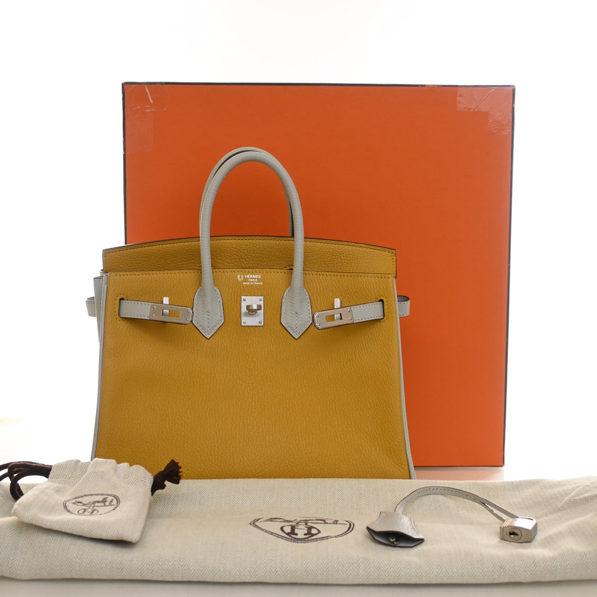 Pre-Owned Hermès Birkin 25 Moutarde Chevre Mysore Leather, shown with dust bag and packaging