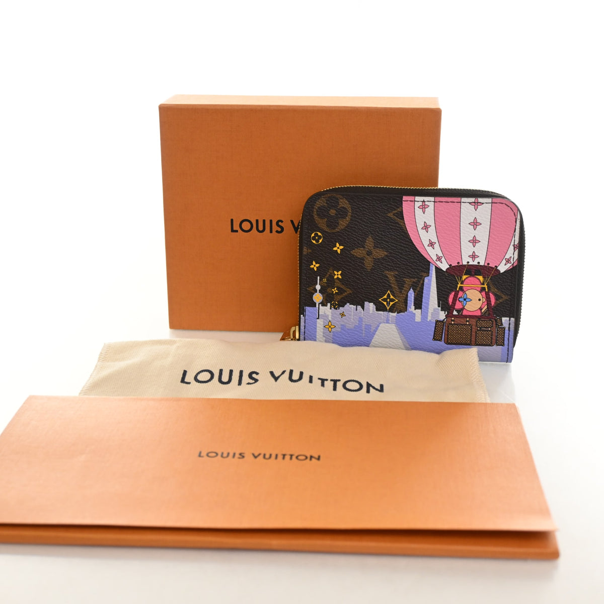 Pre-Owned Louis Vuitton Monogram Christmas Animation Zippy Coin Purse, shown with dust bag and packaging