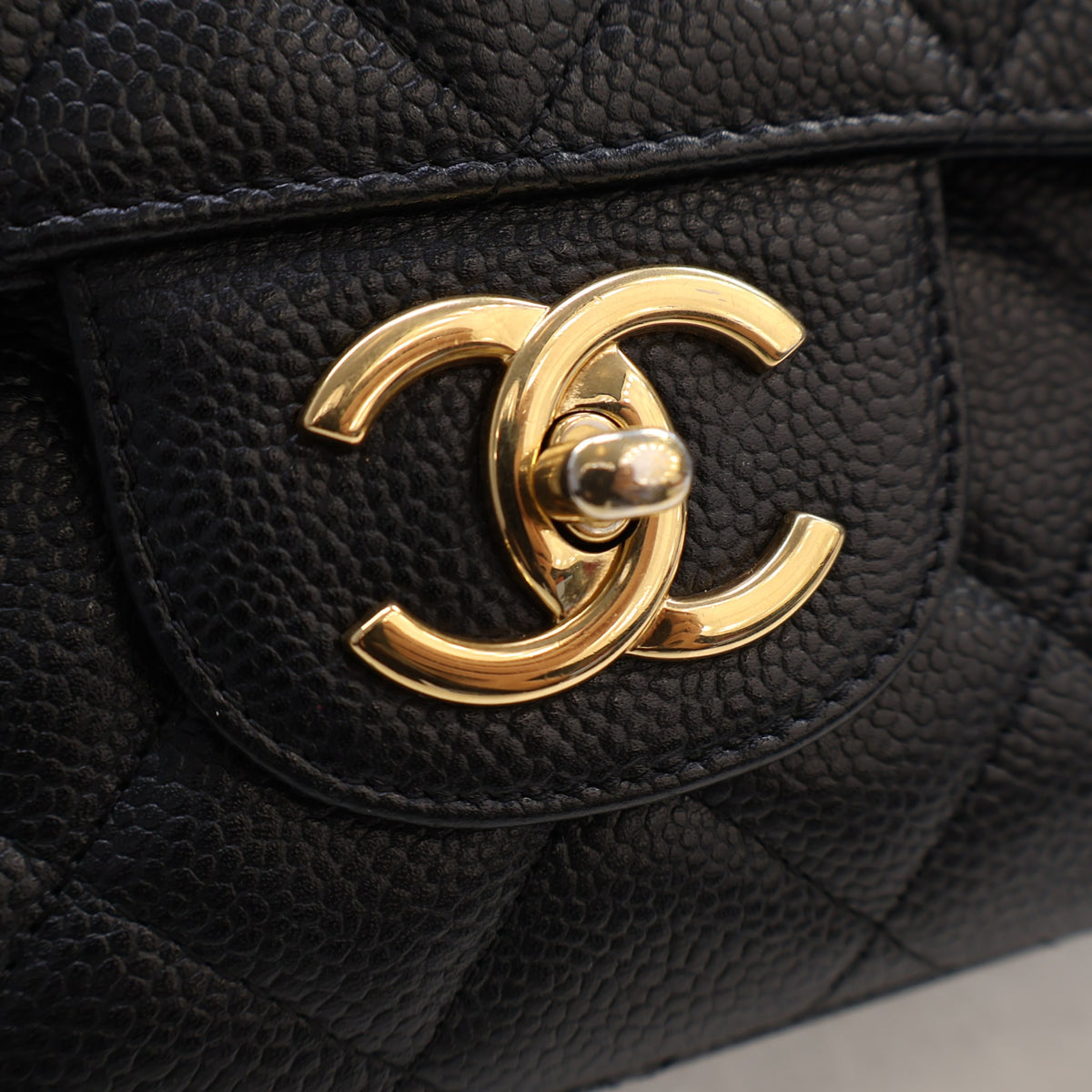Pre-Owned Chanel Classic Double Flap Maxi Caviar Leather Bag, gold hardware close-up