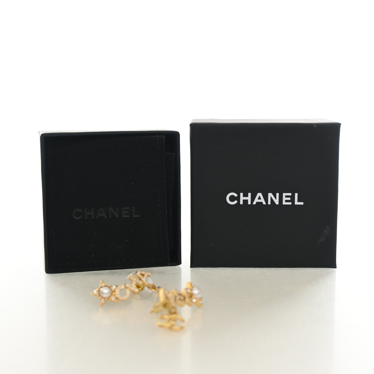 Pre-Owned Chanel Crystal CC Star Earrings, shown with dust bag and packaging
