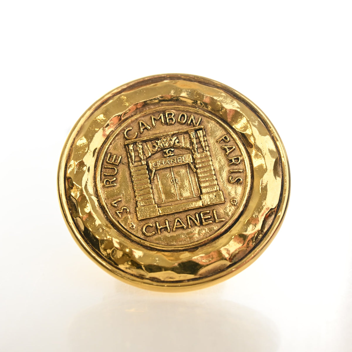 Vintage Chanel Brooch 31 Rue Cambon Medallion, gold hardware close-up