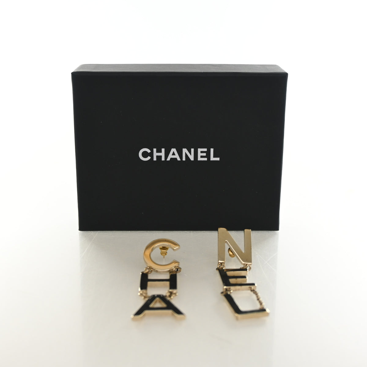 Pre-Owned Chanel 'cha' 'nel' Letter Drop Earrings, shown with dust bag and packaging