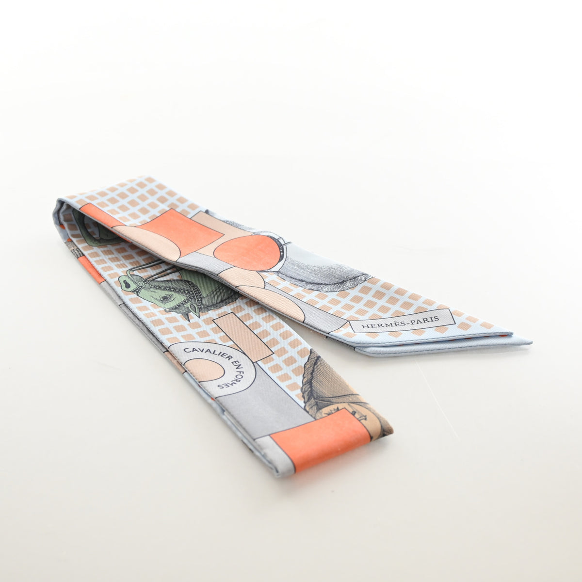 Pre-Owned Hermès Cavalier En Formes Silk Twilly, flat lay, authenticated at Luxe Du Jour