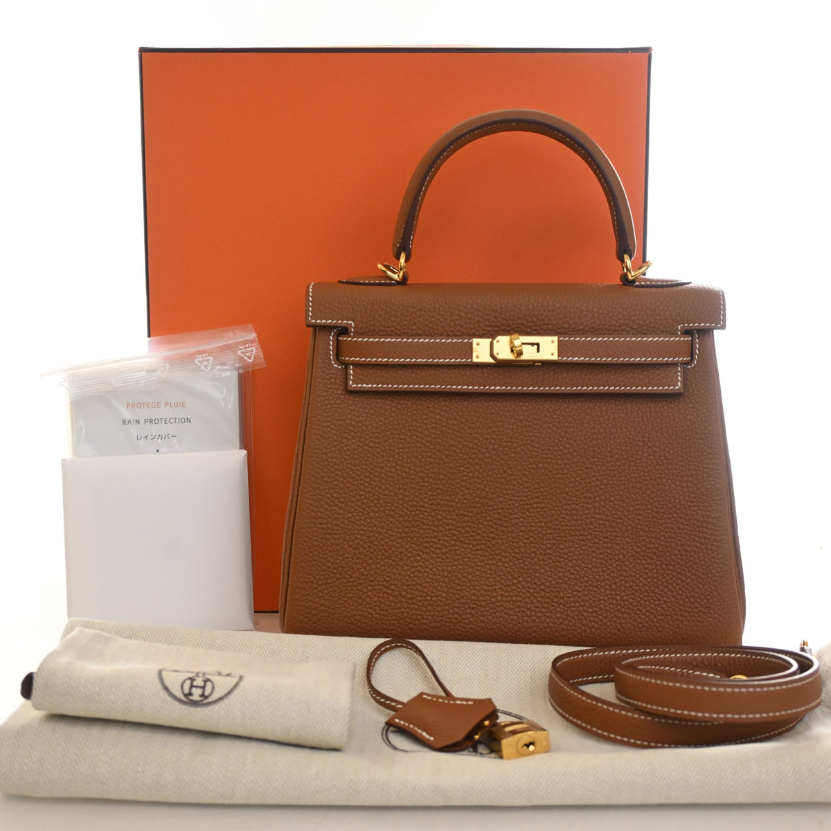 Pre-Owned Hermès Kelly 25 Gold Togo Leather, shown with dust bag and packaging