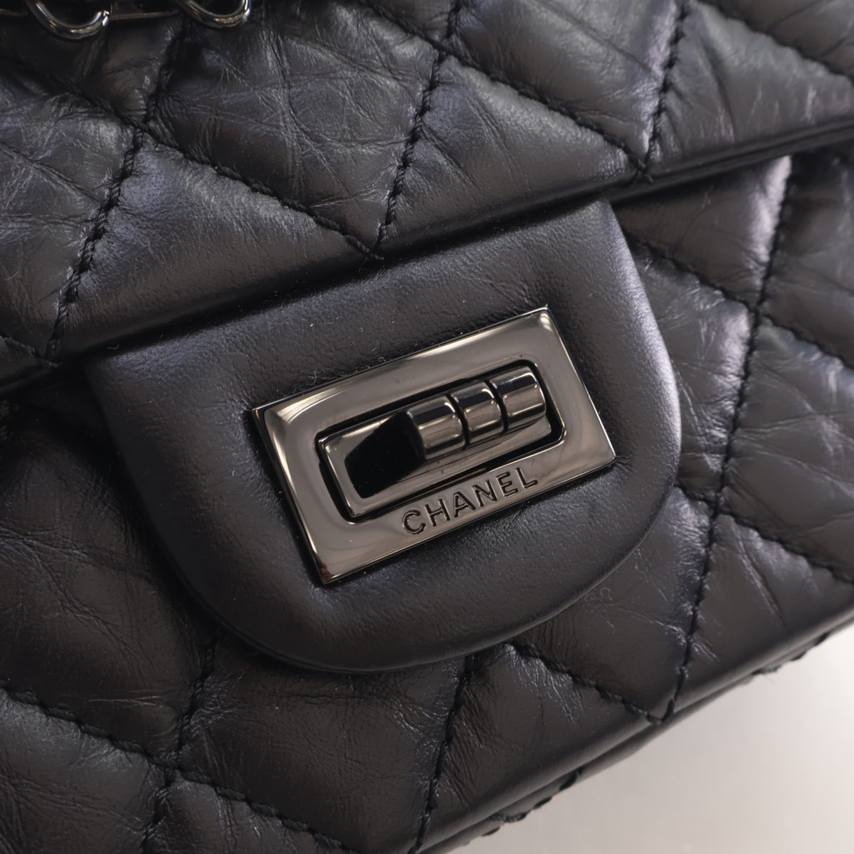 Pre-Owned Chanel Flap Bag Mini Aged Calfskin Reissue 2.55, silver hardware close-up