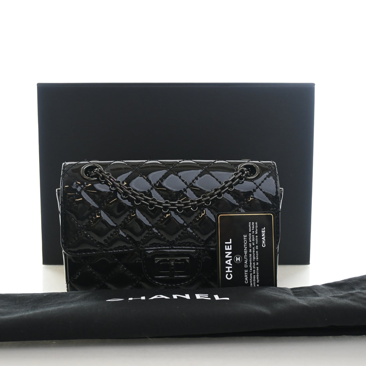 Pre-Owned Chanel Flap Bag 224 Patent Leather Reissue 2.55, shown with dust bag and packaging